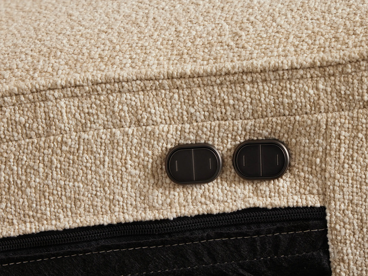 Front view of a cream Borough Two-Piece Motion Sofa, featuring two seats, horizontal tufting on backrests, and upholstered armrests.