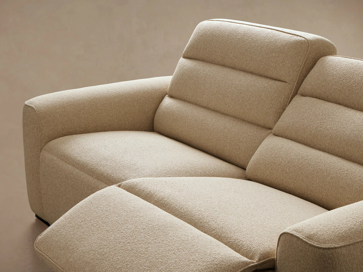 Close-up of the textured beige fabric and two black motion control buttons on the Borough Two-Piece Motion Sofa.
