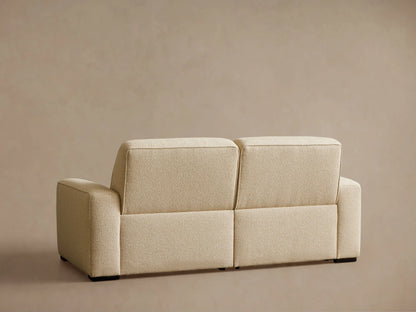 Close-up of beige Borough Two-Piece Motion Sofa, showing textured fabric, horizontal tufting, and extended footrest.