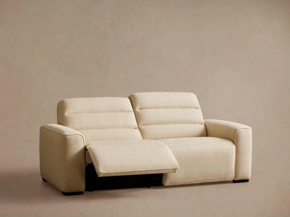 Rear view of the beige Borough Two-Piece Motion Sofa, showing its two distinct back cushions and armrests.