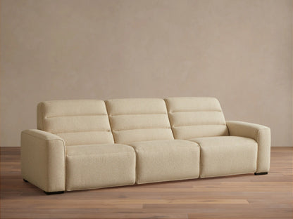 Front view of the light cream Borough Three-Piece Motion Sofa with horizontal stitched backrests and block arms.