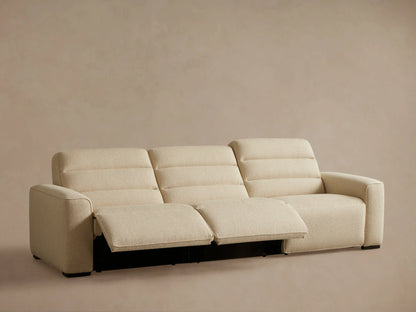 Rear view of the cream Borough Three-Piece Motion Sofa, showing its three textured fabric sections and dark feet.