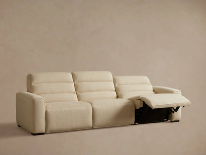 Front view of light beige Borough Three-Piece Motion Sofa‚Ñ¢ with both end seats reclined and footrests extended.