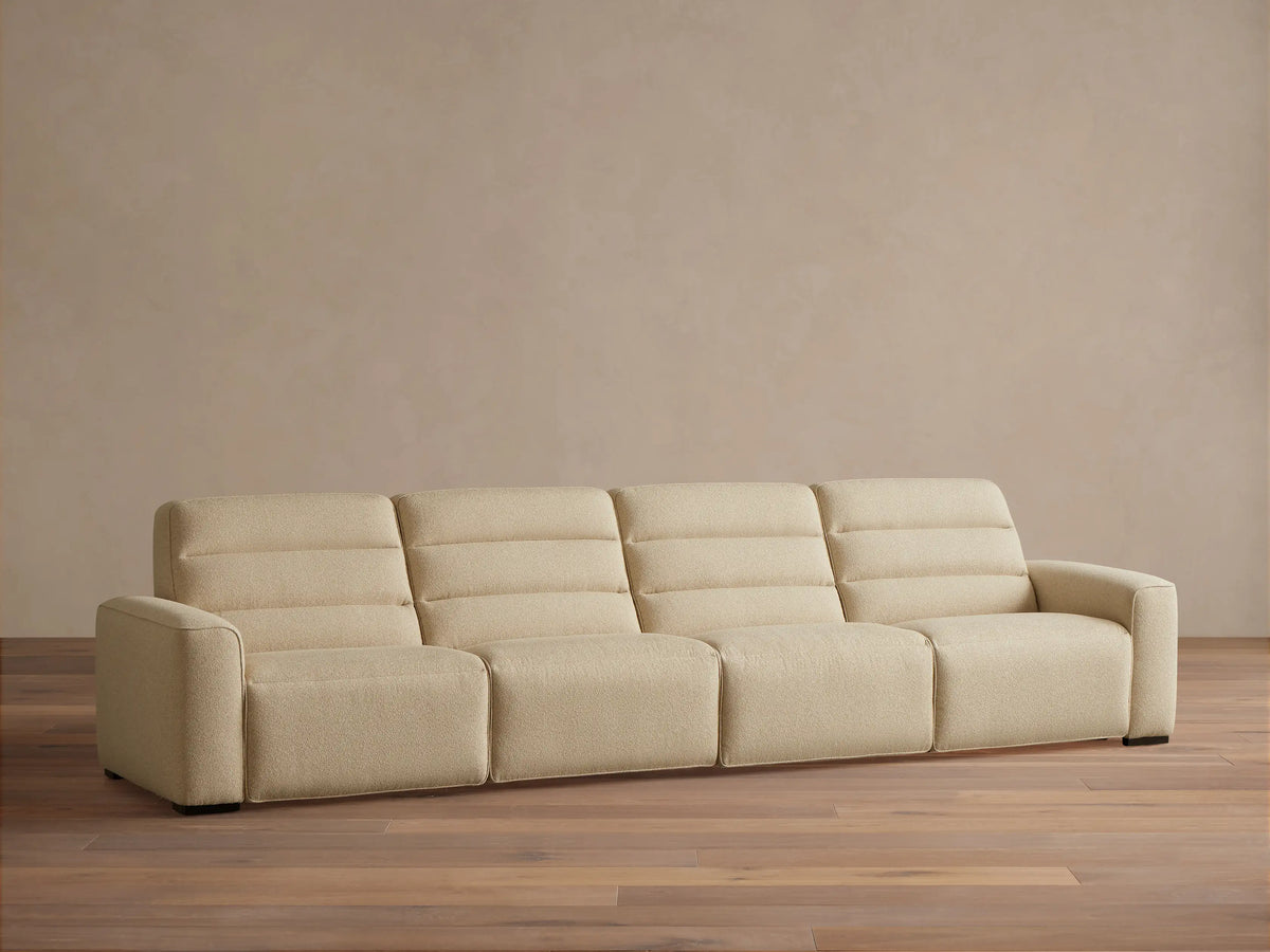 Front view of the cream Borough Four-Piece Motion Sectional with horizontally stitched backrests.