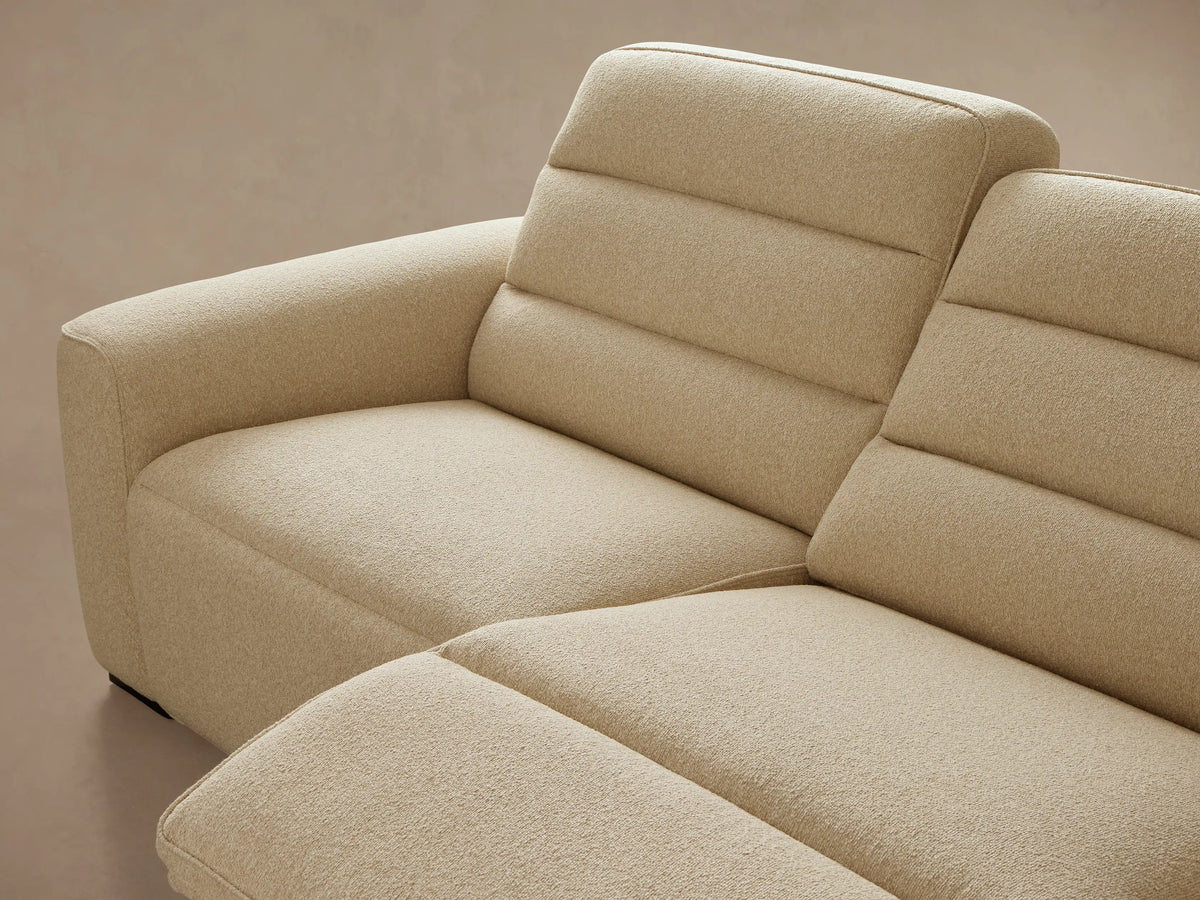 Front view of a cream Borough Four-Piece Motion Sectional, showing its textured fabric and individual seat and back cushions.