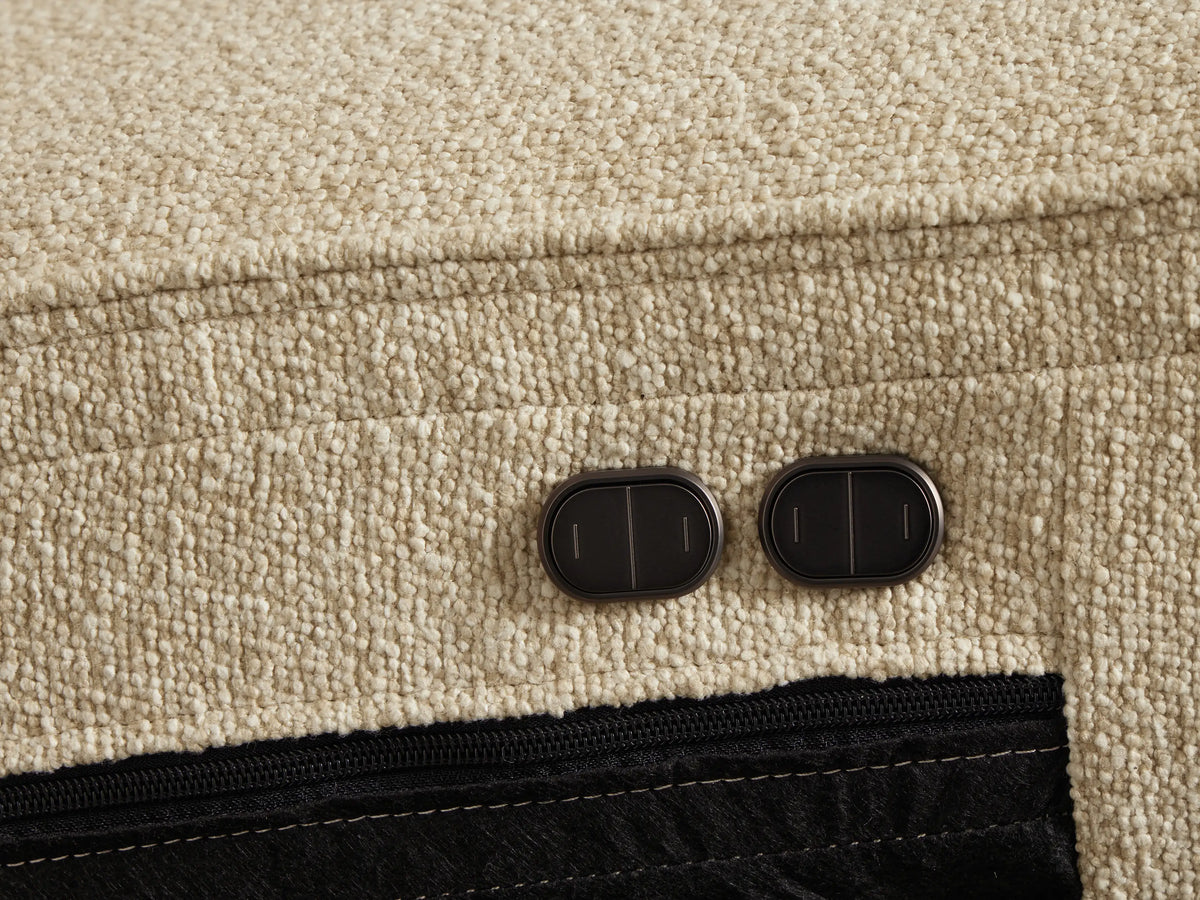 Close-up of the Oatmeal Borough Four-Piece Motion Sectional, showing textured fabric, horizontal tufting, and left armrest.