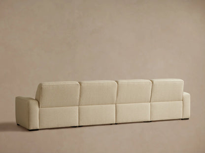 Close-up of the beige textured fabric upholstery on the Borough Four-Piece Motion Sectional, showing two dark motion control buttons.