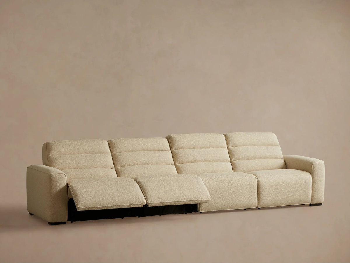Rear view of Cream Borough Four-Piece Motion Sectional, showing four upholstered sections and a left armrest.