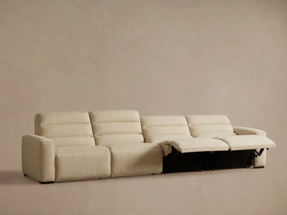 Front view of the beige textured fabric Borough Four-Piece Motion Sectional, with the left recliner's footrest extended.