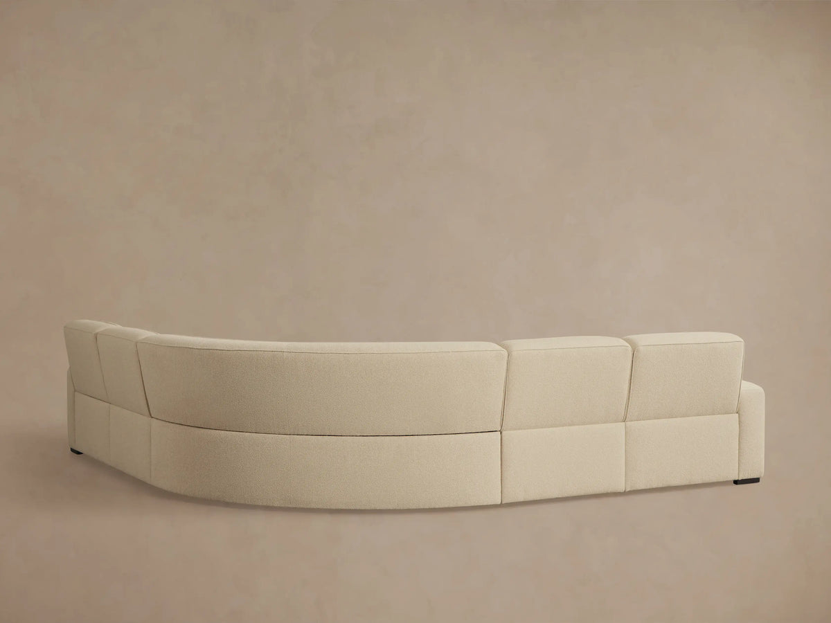 Close-up of two dark, oval motion controls embedded in the cream textured fabric of the Borough Five-Piece Motion Corner Sectional.