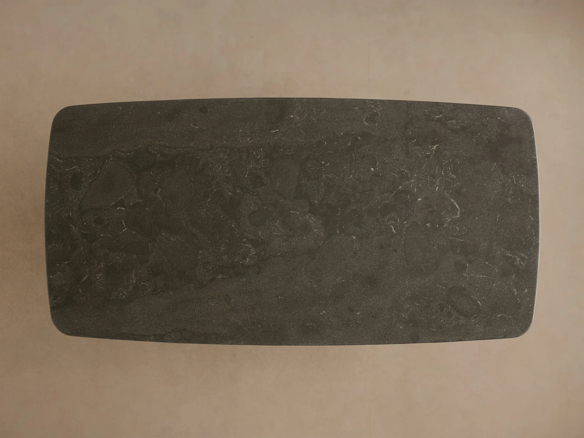 Front view of the Saint Germain Stone Coffee Table with Dauphine Base, featuring a dark gray stone top and two light oak wood curved bases.