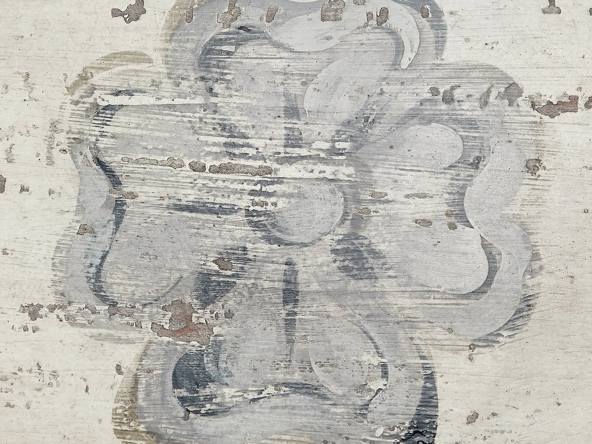 Top of Biancca Bell‚ÄôArte Dining Table: distressed Antique White surface with a central Antique Grey floral and scroll design.