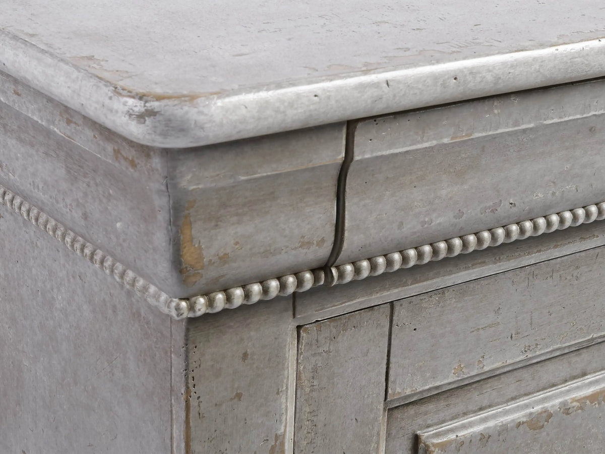 Giada Bell'Arte Console, a distressed antique grey cabinet with sliding panel doors, ornate top trim, and a decorative base.
