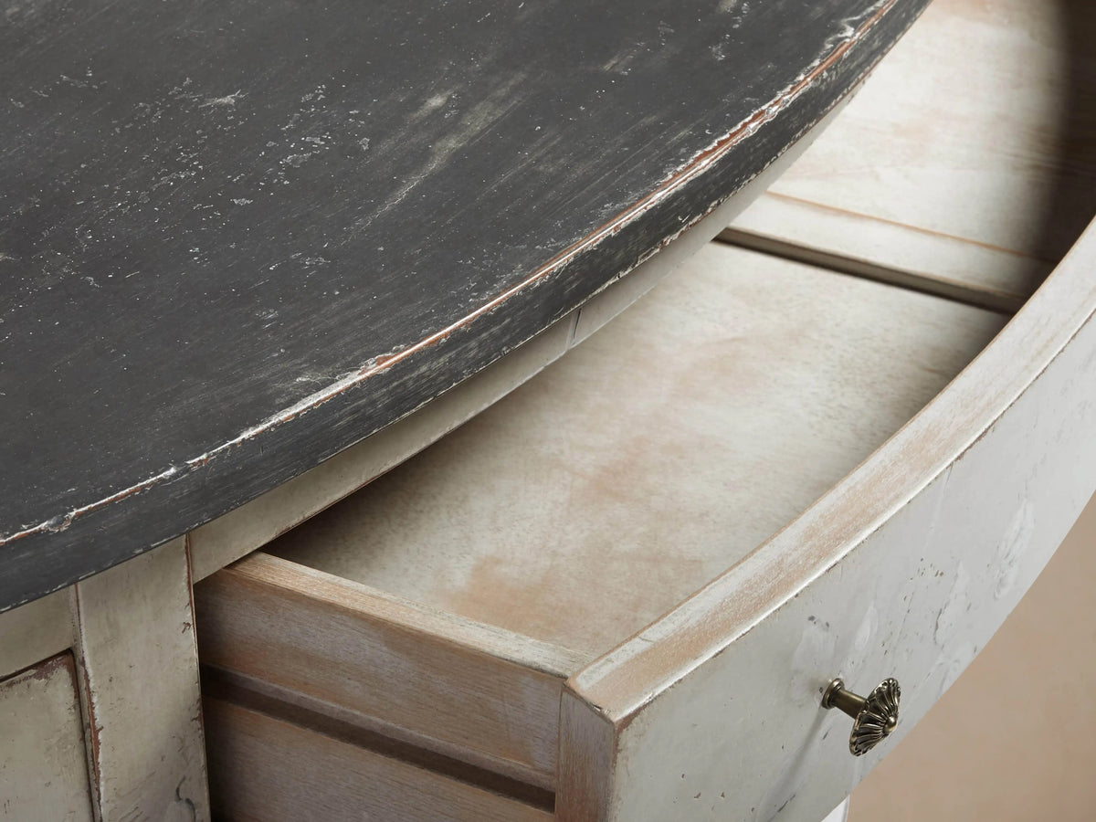 Sofia Bell'Arte Demilune Cabinet with curved design, hand-painted floral motifs, distressed antique white finish, and dark top.