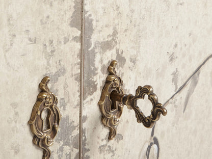 Sofia Bell'Arte Demilune Cabinet with cream finish, hand-painted bird and vine motifs, curved front, and tapered legs.