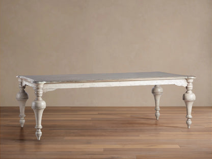 Alessia Bell‚ÄôArte Dining Table: Dark grey rectangular top, distressed antique ivory/beige carved base & legs on wood floor.