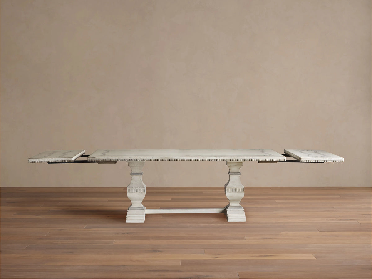 Cerea Ribbon Bell'Arte Dining Table: Distressed off-white with subtle grey wash, hand-painted ribbon border, ornate trestle base.