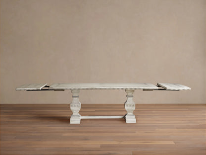 Cerea Ribbon Bell'Arte Dining Table: Distressed off-white with subtle grey wash, hand-painted ribbon border, ornate trestle base.