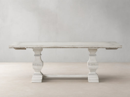 Cerea Ribbon Bell'Arte Dining Table: Distressed off-white with subtle grey wash, hand-painted ribbon border, ornate trestle base.