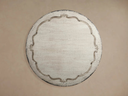 Cerea Bell'Arte Round Dining Table base, showing distressed gray-brown pedestal with carved details and ribbed tabletop edge.
