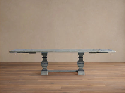 Cerea Gallery Bell'Arte Dining Table in distressed gray finish with ornate carved pedestal legs and rectangular top, on wood floor.