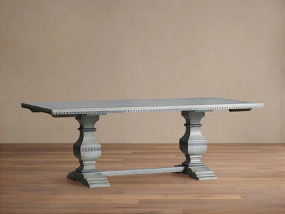 Cerea Gallery Bell'Arte Dining Table with distressed gray finish, rectangular top, two extensions, and carved double pedestal legs on wood floor.