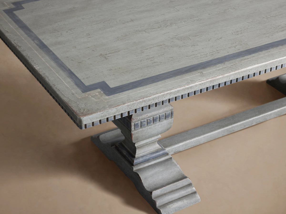 Cerea Gallery Bell'Arte Dining Table in distressed gray finish, featuring a rectangular top and robust ornate legs on a wooden floor.