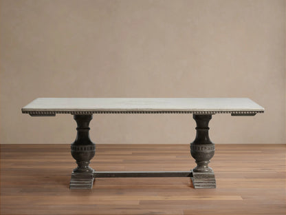 Florence Bell‚ÄôArte Dining Table. Rectangular Ivory Grey top with carved dark edge, supported by two ornate Dark Rust pedestal bases.