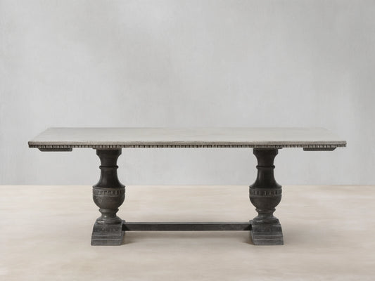 Florence Bell‚ÄôArte Dining Table. Rectangular Ivory Grey top with carved dark edge, supported by two ornate Dark Rust pedestal bases.