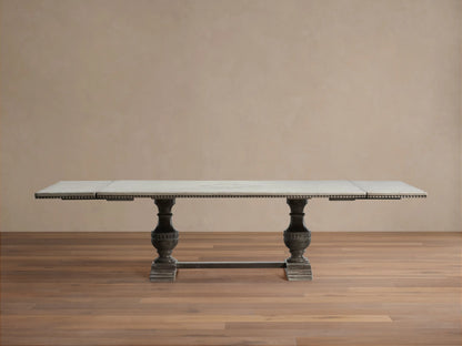 Florence Bell‚ÄôArte Dining Table. Rectangular Ivory Grey top with carved dark edge, supported by two ornate Dark Rust pedestal bases.