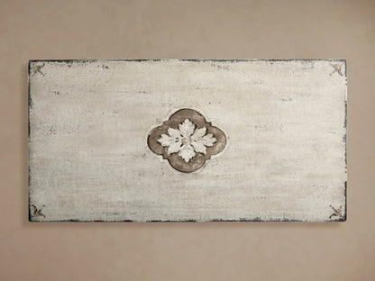 Close-up of Florence Center Floral Bell‚ÄôArte Dining Table's distressed Ivory Grey top with carved edge & Dark Rust floral details.