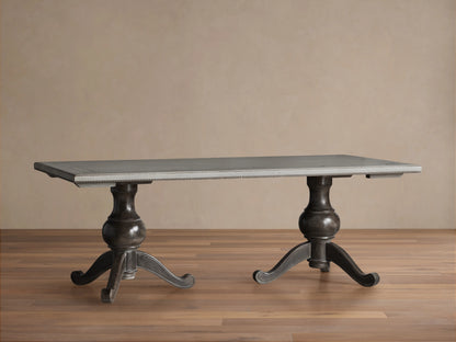 Girardi Geo Link Bell'Arte Dining Table with antique white top, geometric grey border, and two ornate dark wooden pedestals.