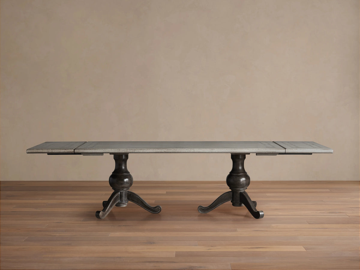 Girardi Geo Link Bell'Arte Dining Table with Antique White top, hand-painted geometric border in Antique Grey on wooden pedestal legs.