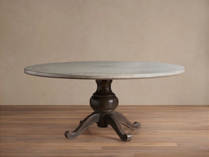 Round dining table with Antique White top, dark curved pedestal base on wooden floor, hand-painted geometric border.
