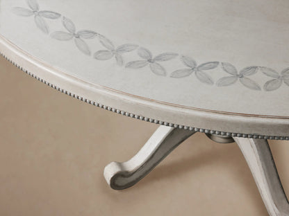 Round Girardi Margherita Bell'Arte dining table in distressed antique white with hand-painted edge pattern and pedestal base.