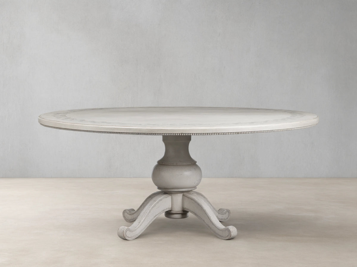 Round Girardi Margherita Bell'Arte dining table in distressed antique white with hand-painted edge pattern and pedestal base.