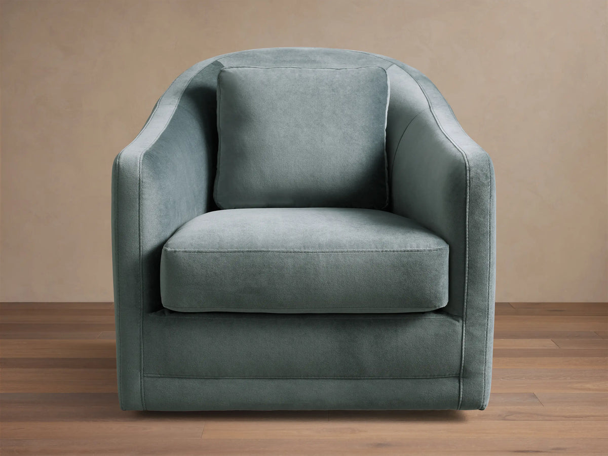 Front view of the Dusty Blue-Green Bianca Swivel Chair with rounded arms, loose seat, and back cushion.