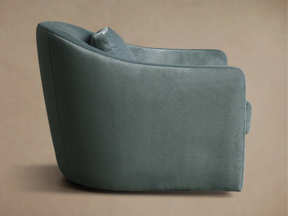 Rear view of the dusty teal Bianca Swivel Chair, showcasing its soft, textured fabric and gracefully curved backrest.