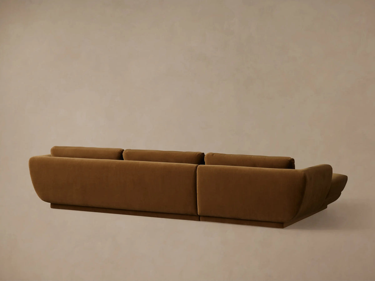 Fontana Two-Piece Chaise Sectional in rich brown fabric, with rounded armrest, three back cushions, and a low, distinct base.