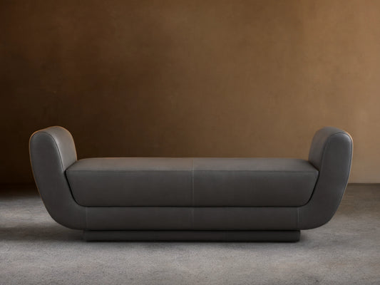 Front view of a dark gray Fontana Leather Bench with curved arms and a sleek, modern design.