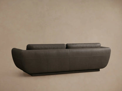 Close-up of the dark gray Fontana Leather Sofa, featuring a rounded armrest, seat, and back cushions with fine stitching.