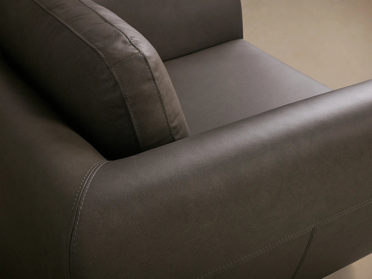 Front view of the dark gray Fontana Leather Swivel Chair, showing its sleek curved arms and a visible swivel base.