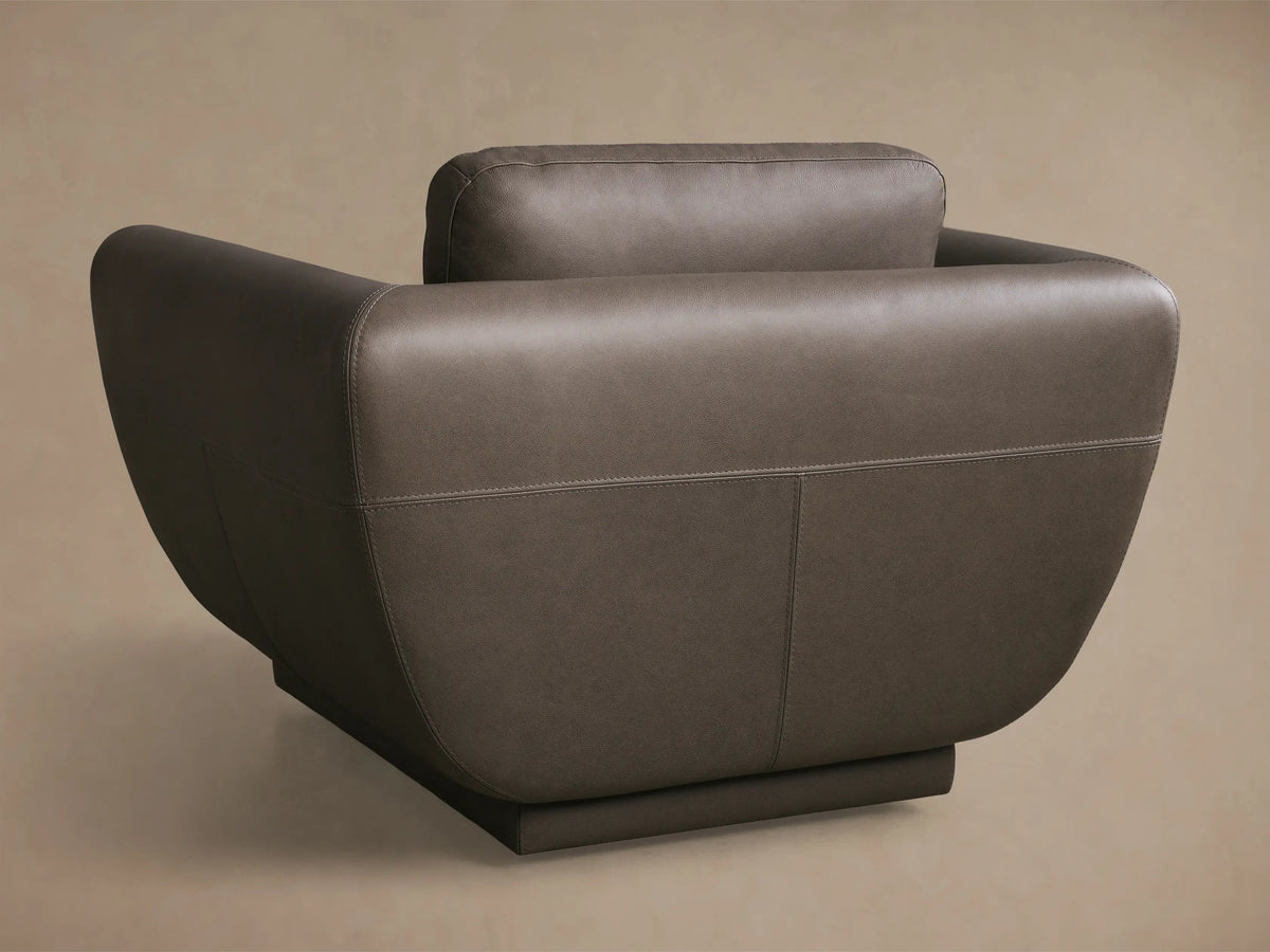 Close-up of dark gray leather on the Fontana Leather Swivel Chair, showing armrest, back cushion, and contrasting stitching.
