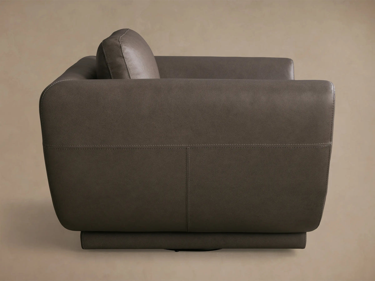 Rear view of the taupe Fontana Leather Swivel Chair, featuring smooth leather upholstery and detailed stitching.