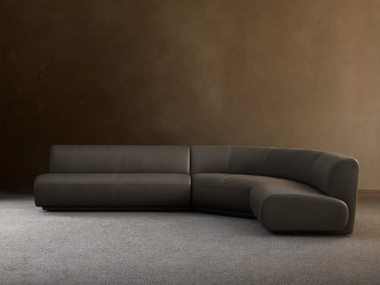 Front view of the Charcoal Gianni Leather Three-Piece Armless Bumper Sectional, featuring a curved corner and straight segments.