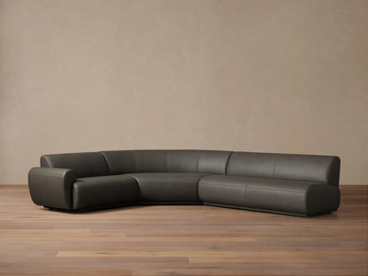Front view of the dark gray Gianni Leather Three-Piece Sectional, featuring a curved, low-profile design.