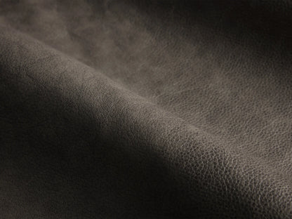 Close-up of the dark grey grained leather on the Gianni Leather Three-Piece Sectional.