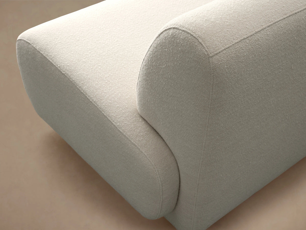 Gianni Armless Four-Piece Chaise Sectional, L-shaped, light cream fabric with soft rounded design, on a wood floor.