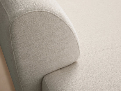 Light beige textured Gianni Chaise, modern style with rounded edges, angled view on a wooden floor.
