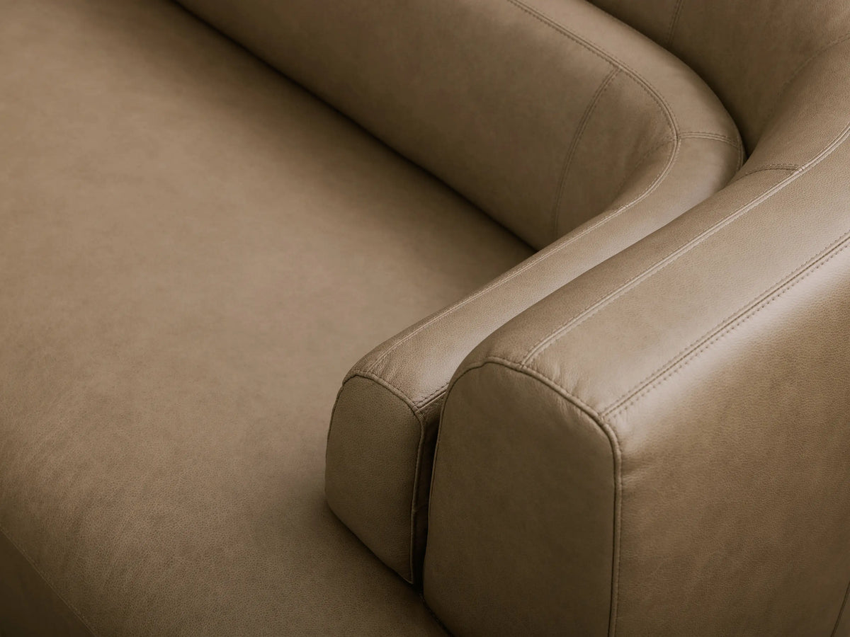Front view of the muted olive-brown Lovina Leather Three-Piece Bumper Sectional with a curved left chaise and lumbar supports.